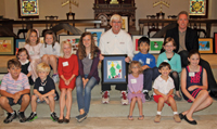 Children who
                                          created the holiday cards
                                          gather with Bobby Cremins