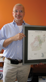 Dr. Sweat holding up a map